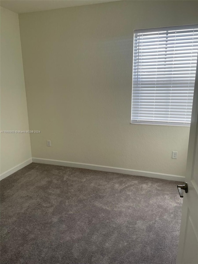 empty room with dark carpet