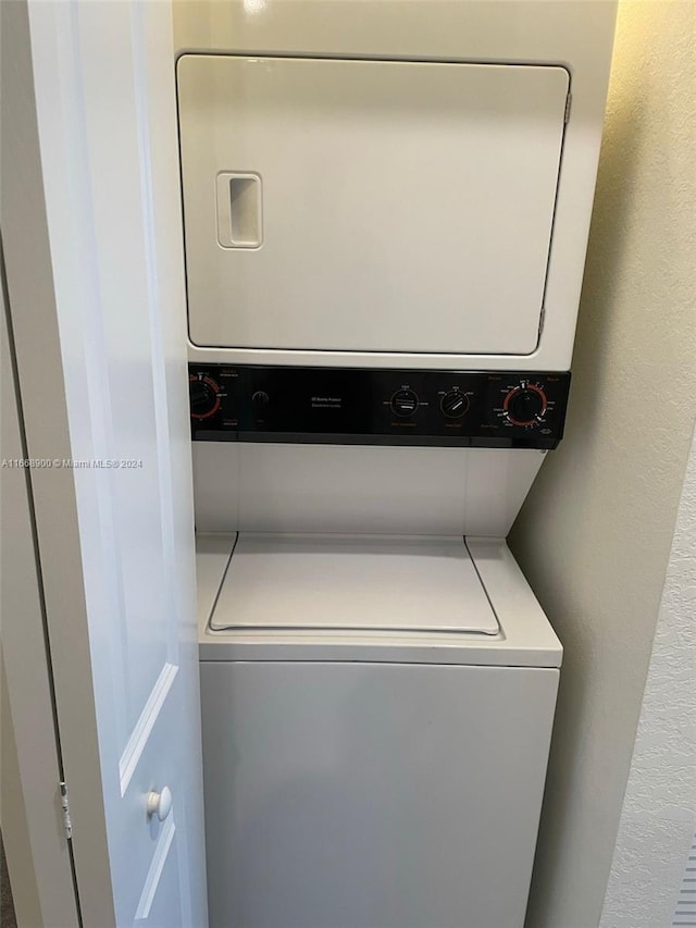 laundry room featuring stacked washer and dryer