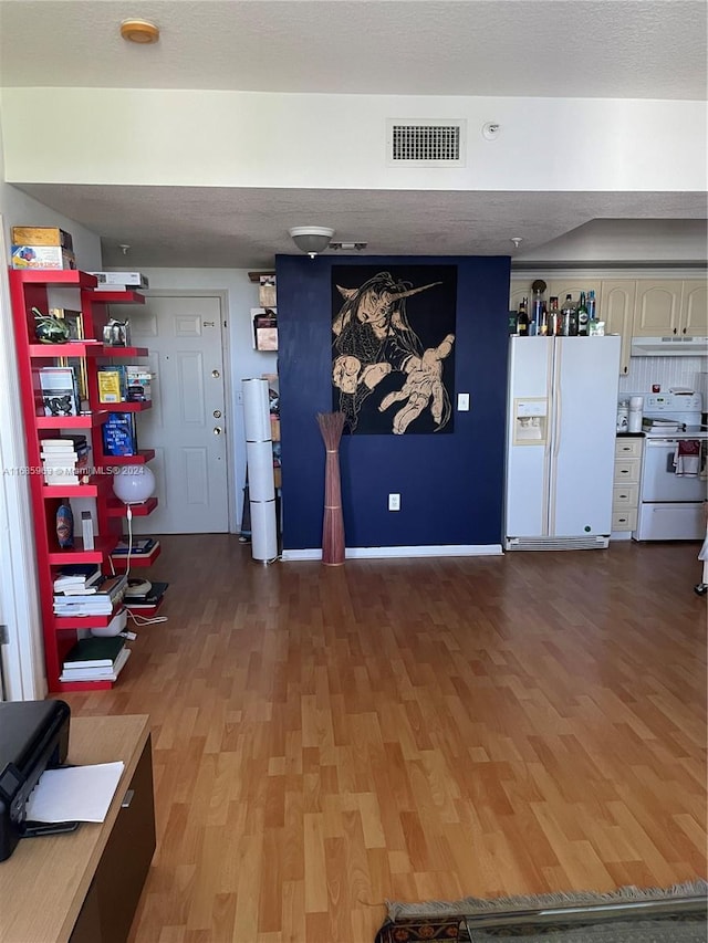 interior space with a textured ceiling and dark hardwood / wood-style flooring