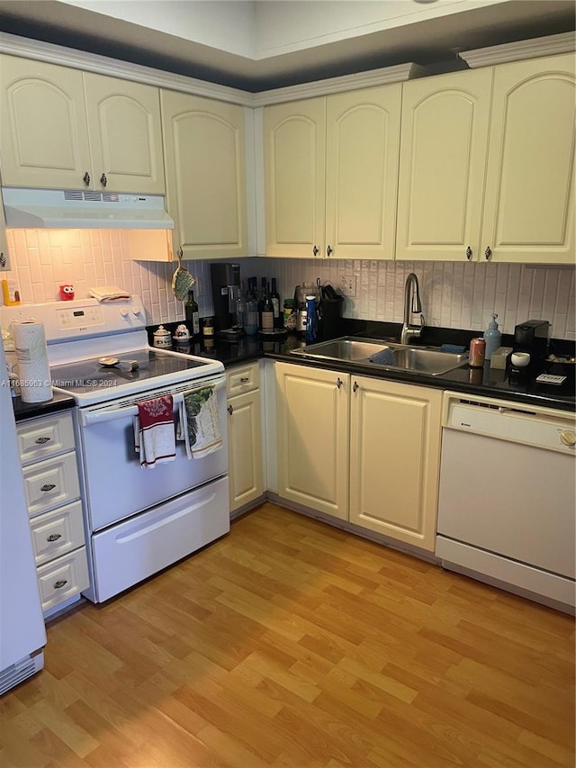 kitchen with decorative backsplash, sink, light wood-type flooring, and white appliances