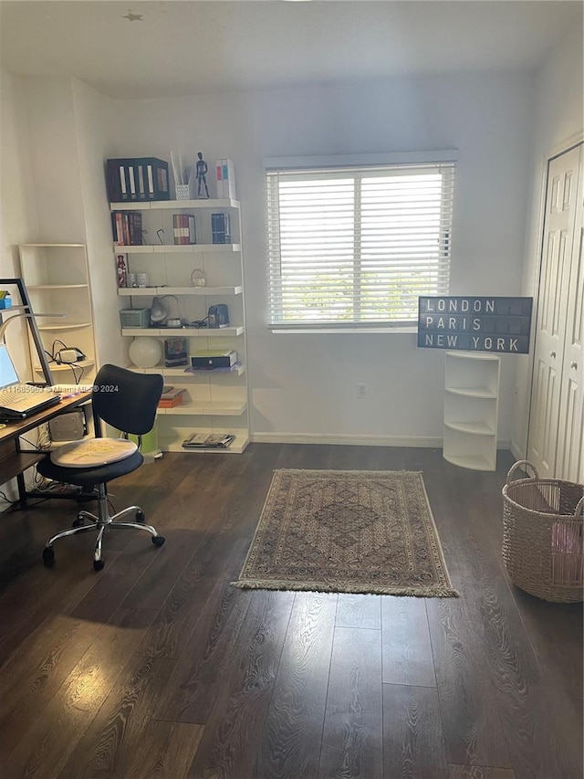 home office with dark hardwood / wood-style flooring