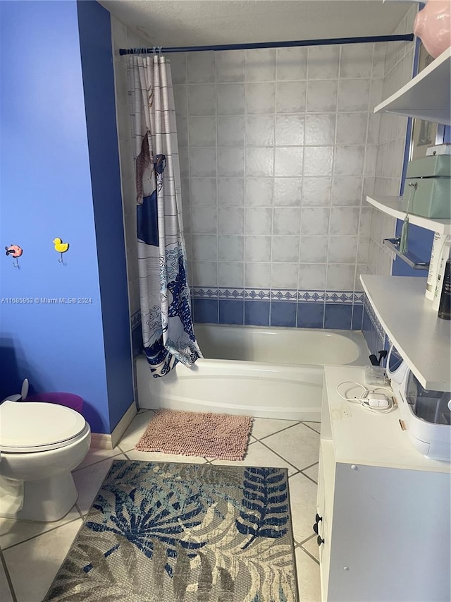 full bathroom featuring vanity, toilet, shower / bath combo with shower curtain, and tile patterned flooring