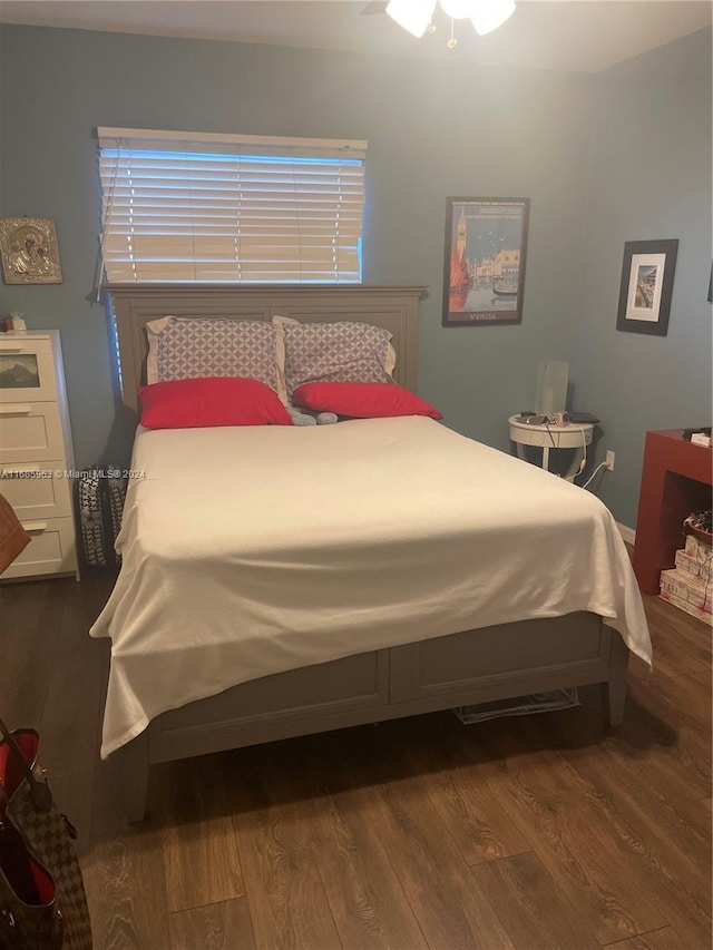 bedroom with ceiling fan and hardwood / wood-style flooring