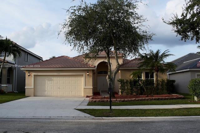 1380 Meadows Blvd, Weston, FL 33327 - mediterranean / spanish-style house featuring a garage, stucco siding, concrete driveway, and a tile roof