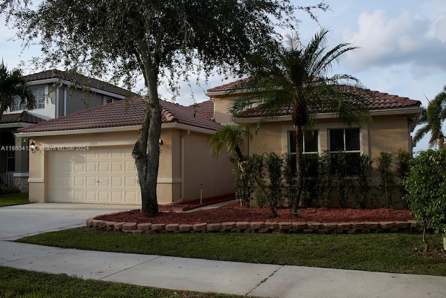 1380 Meadows Blvd, Weston, FL 33327 - view of front facade with a garage, concrete driveway, a tile roof, and stucco siding