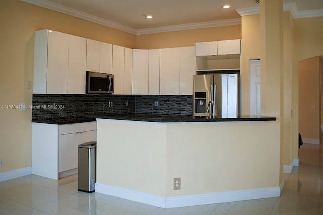 1380 Meadows Blvd, Weston, FL 33327 - kitchen with stainless steel appliances, decorative backsplash, white cabinets, arched walkways, and ornamental molding