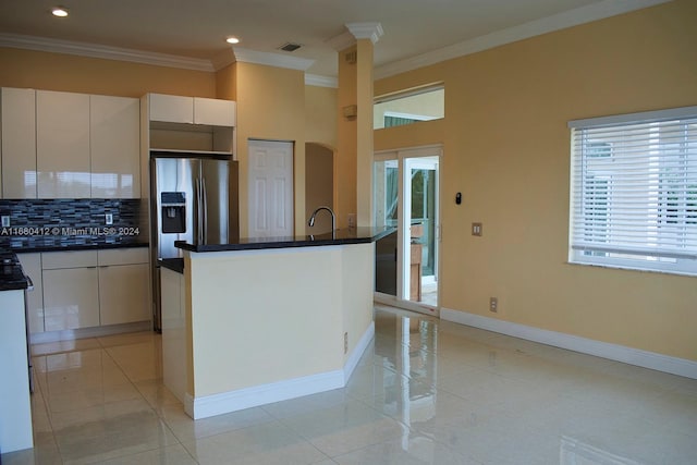 kitchen with decorative backsplash, ornamental molding, white cabinetry, stainless steel fridge with ice dispenser, and a kitchen island