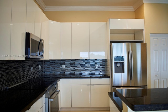 kitchen with decorative backsplash, appliances with stainless steel finishes, white cabinetry, and crown molding