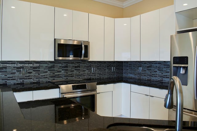 1380 Meadows Blvd, Weston, FL 33327 - kitchen featuring stainless steel appliances, crown molding, white cabinetry, backsplash, and dark stone countertops