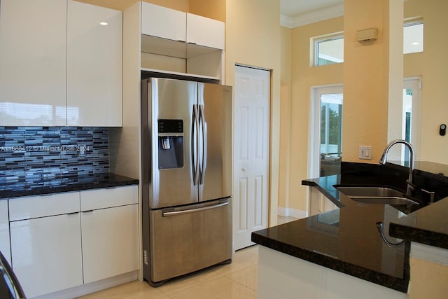 1380 Meadows Blvd, Weston, FL 33327 - kitchen featuring stainless steel fridge, decorative backsplash, dark stone counters, white cabinets, and ornamental molding
