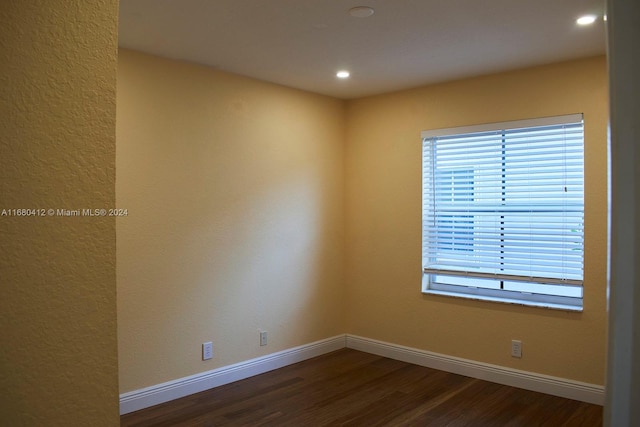 unfurnished room with dark hardwood / wood-style floors