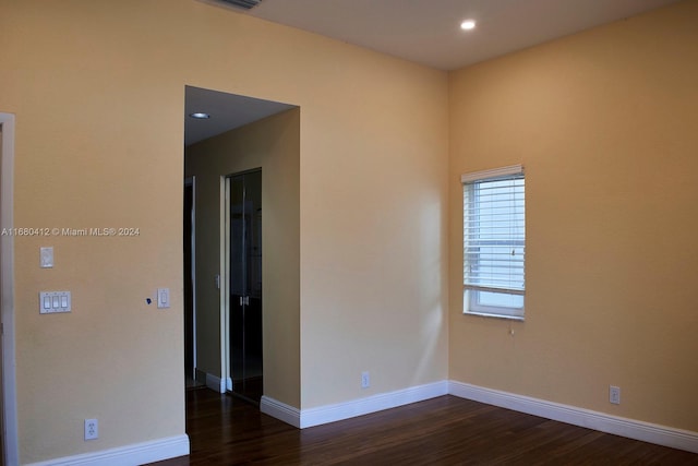 spare room featuring dark wood-type flooring