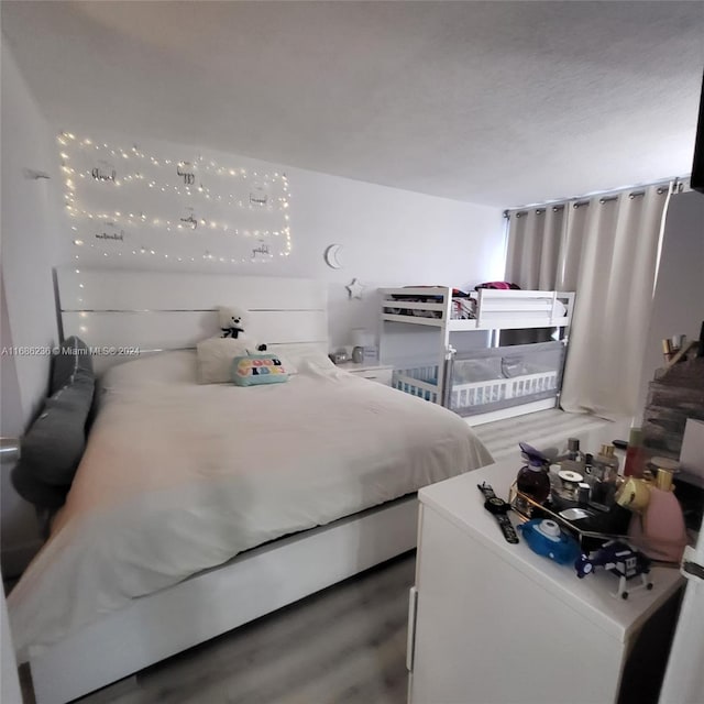 bedroom with dark wood-type flooring