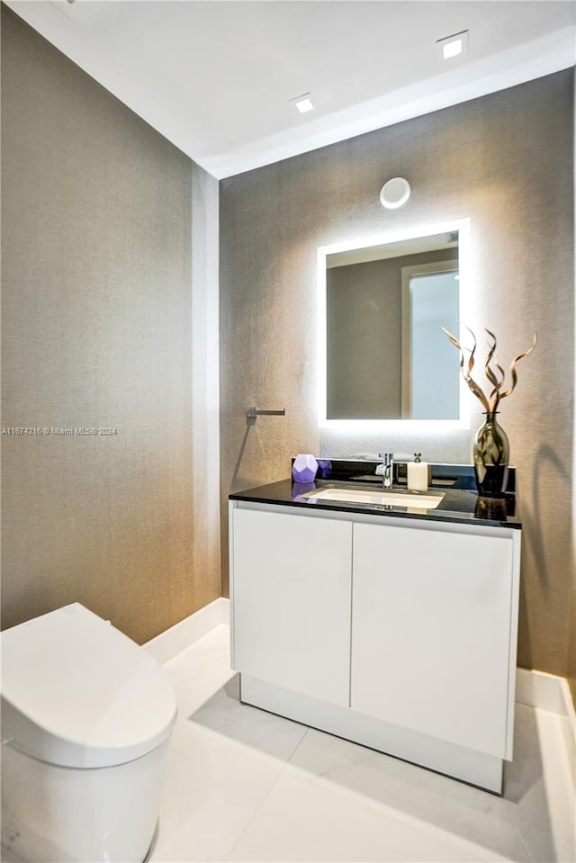 bathroom featuring vanity, toilet, and tile patterned flooring