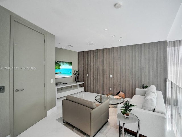 living room featuring a wealth of natural light and wooden walls