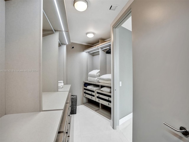 spacious closet with light tile patterned floors