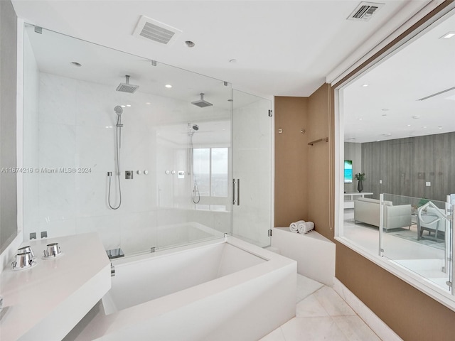 bathroom with tile patterned floors, sink, and shower with separate bathtub