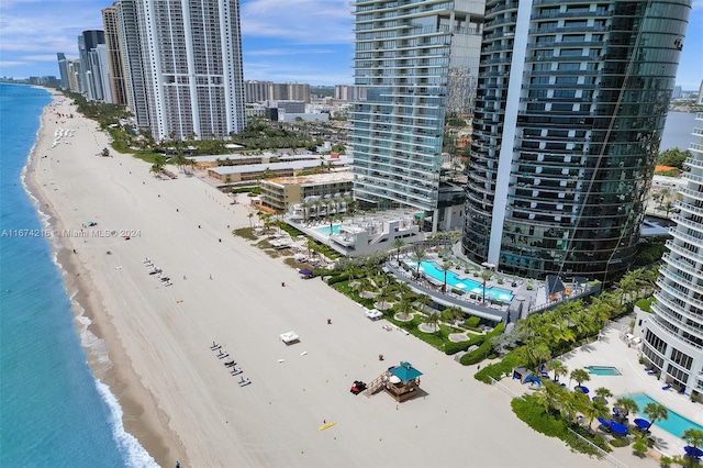 drone / aerial view with a water view and a beach view