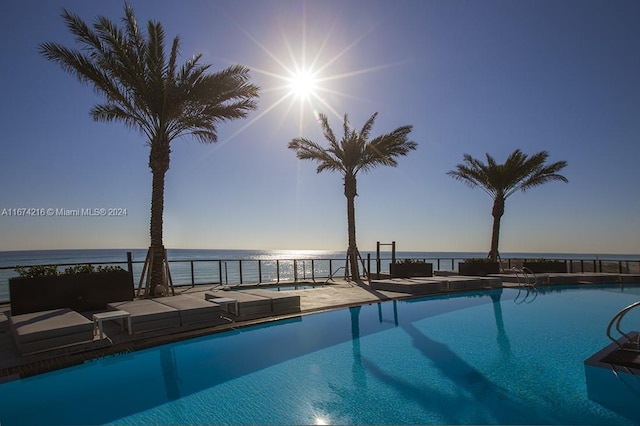 pool at dusk with a water view