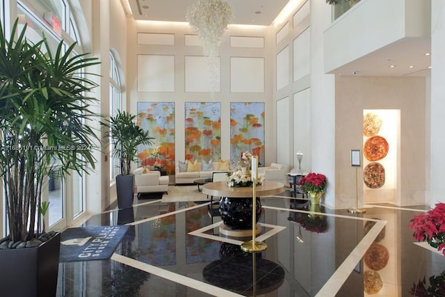 kitchen with white cabinets, a chandelier, and a high ceiling