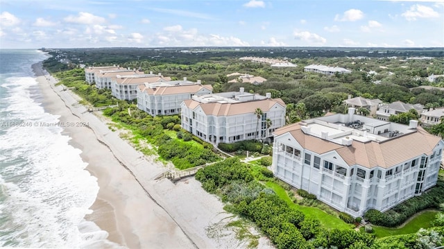 bird's eye view with a water view and a beach view