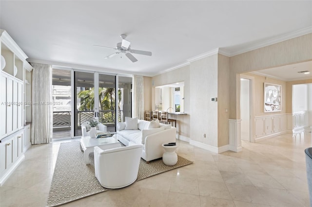 living room with ornamental molding and ceiling fan