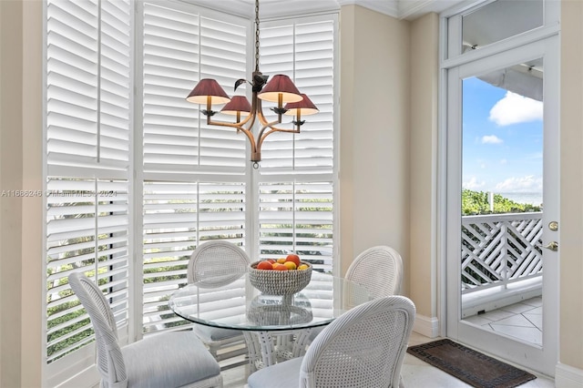 dining space featuring tile patterned floors and an inviting chandelier