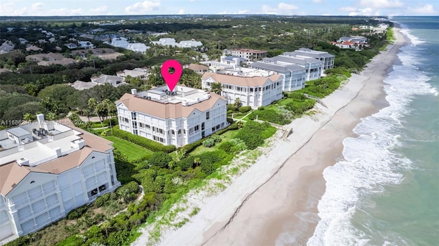 bird's eye view featuring a water view and a beach view