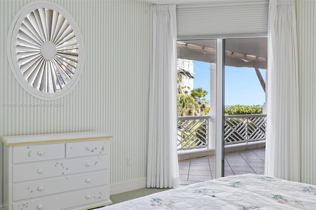 bedroom with access to outside and light tile patterned floors