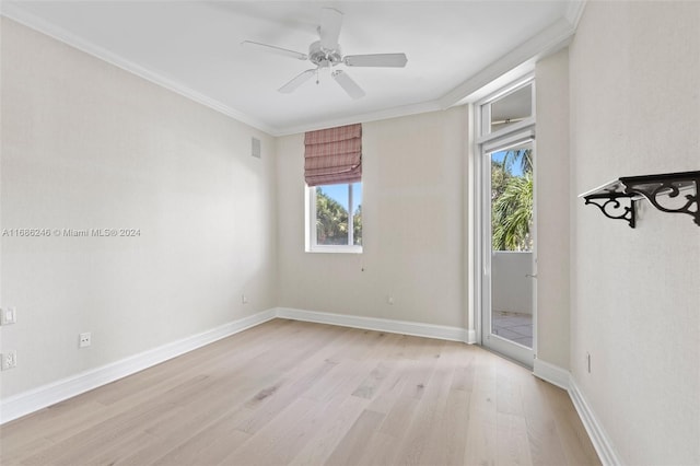 empty room featuring crown molding, light wood-type flooring, and ceiling fan