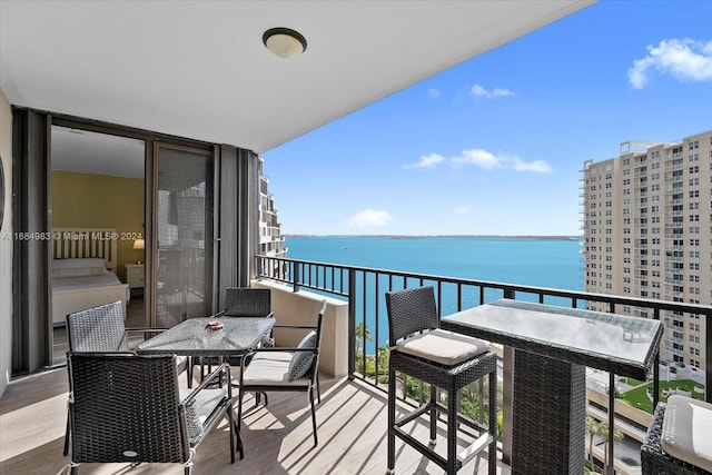 balcony featuring a water view