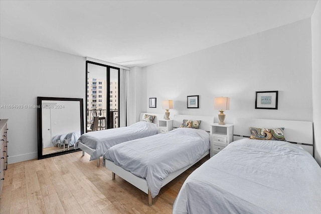 bedroom featuring access to outside and light hardwood / wood-style flooring