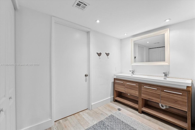 bathroom featuring vanity and wood-type flooring