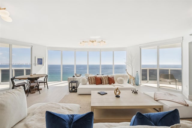 sunroom / solarium featuring a wealth of natural light and a water view