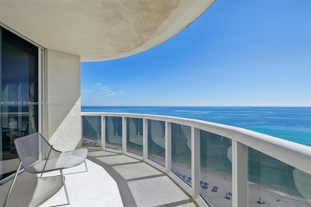 balcony with a view of the beach and a water view