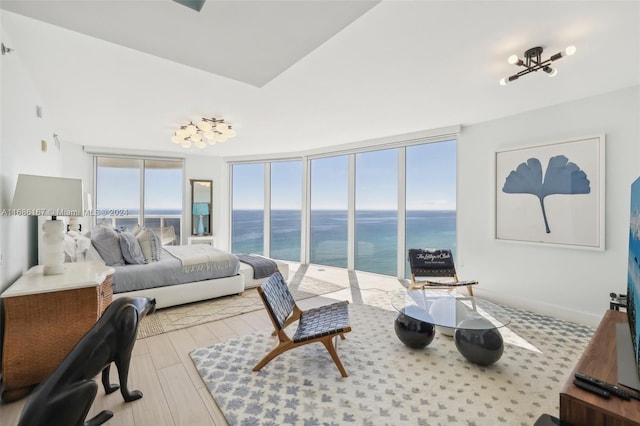 bedroom featuring a water view and light hardwood / wood-style flooring