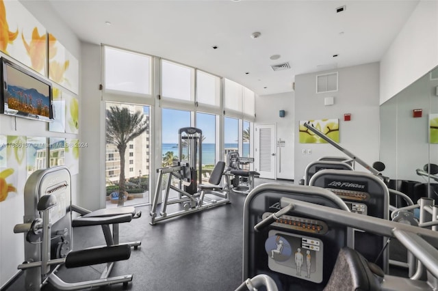 workout area featuring a water view