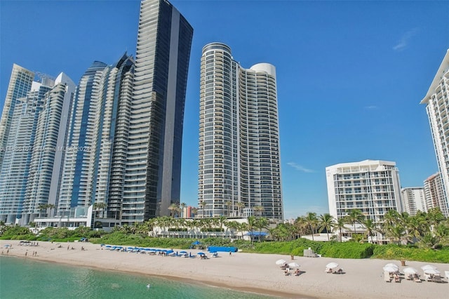 view of building exterior featuring a view of the beach and a water view