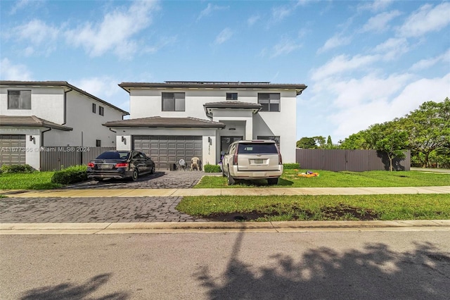 view of front of home with a front yard and a garage