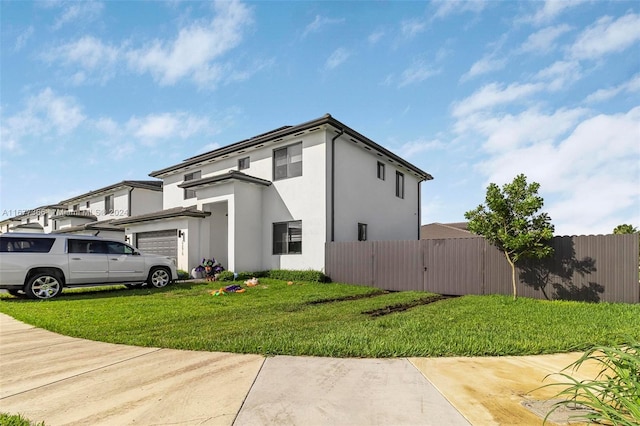 view of property exterior featuring a lawn and a garage