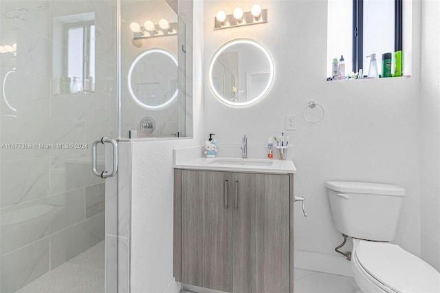 bathroom with toilet, a shower with shower door, and vanity