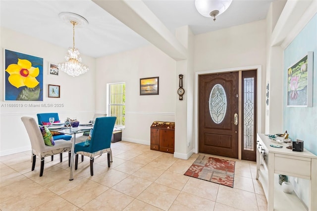 tiled foyer entrance with a chandelier