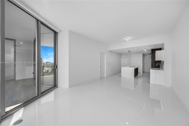 unfurnished living room featuring light tile patterned floors and expansive windows