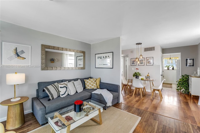 living room featuring hardwood / wood-style floors and a chandelier