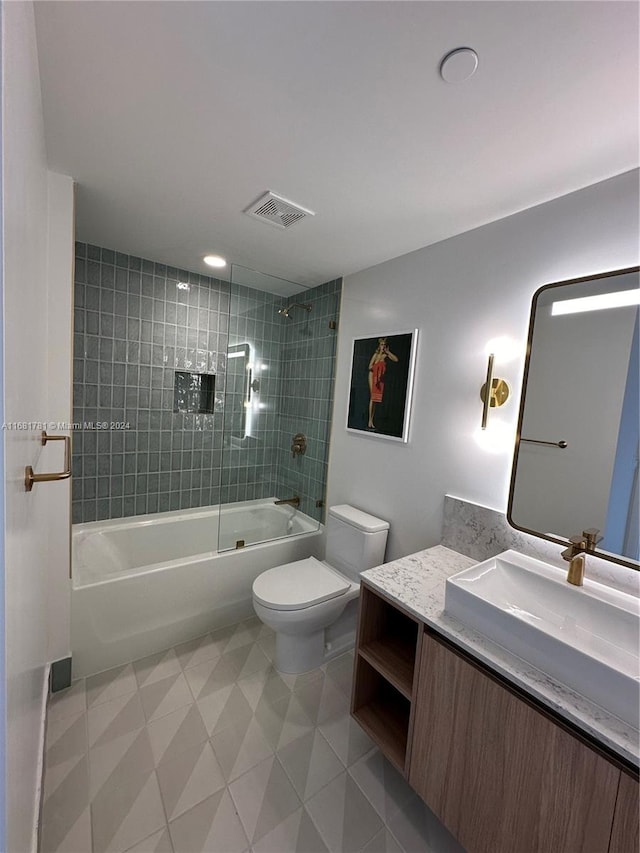 full bathroom featuring vanity, toilet, and tiled shower / bath combo