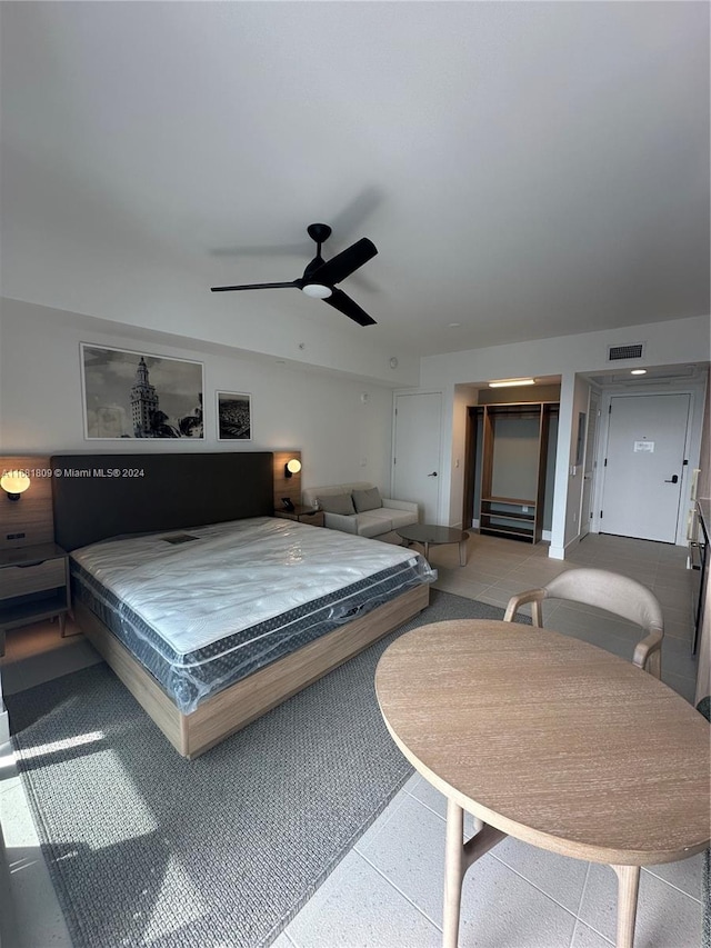 tiled bedroom with ceiling fan