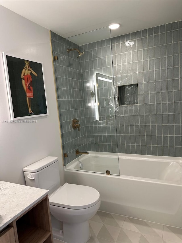 full bathroom featuring toilet, tiled shower / bath combo, and vanity