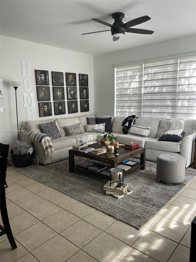 living room with a textured ceiling, tile patterned floors, plenty of natural light, and ceiling fan