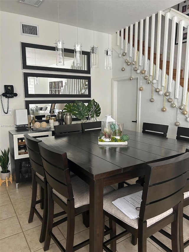 dining space featuring light tile patterned flooring