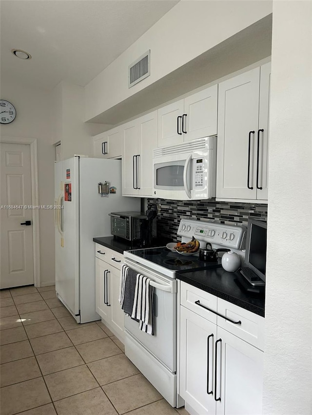 kitchen featuring decorative backsplash, white cabinetry, light tile patterned flooring, and white appliances